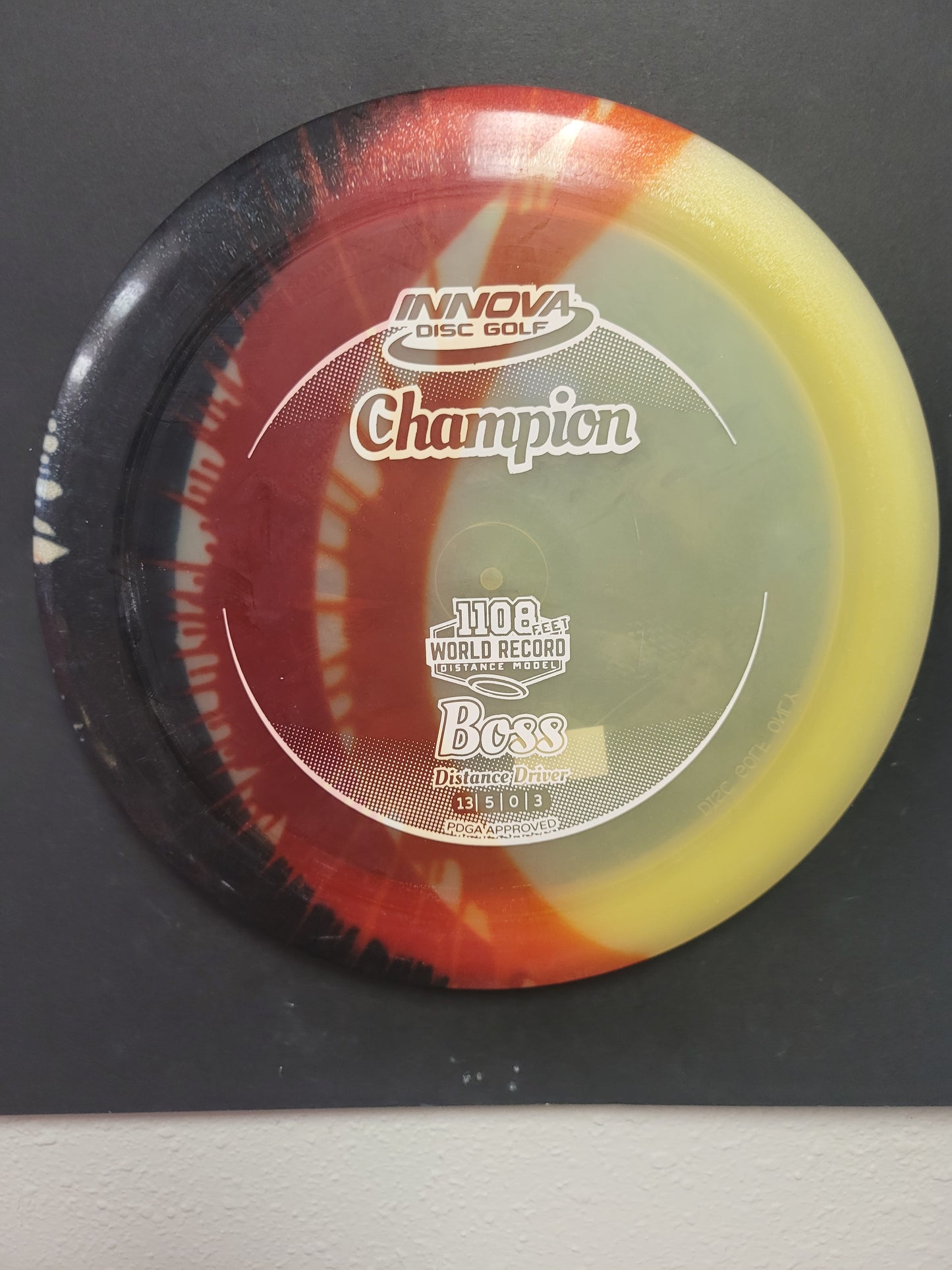 BOSS/CHAMPION DYED PLASTIC/DISTANCE DRIVER
