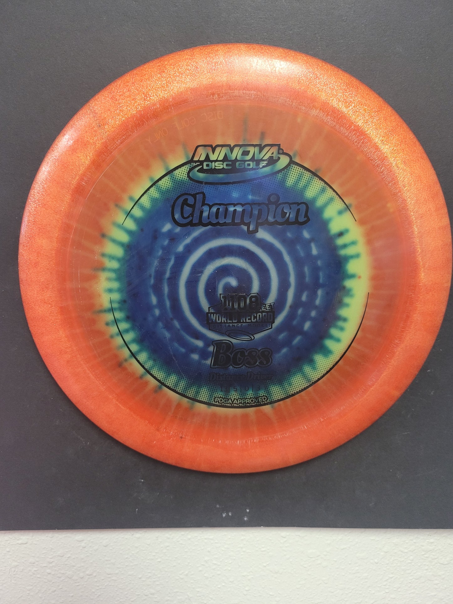 BOSS/CHAMPION DYED PLASTIC/DISTANCE DRIVER